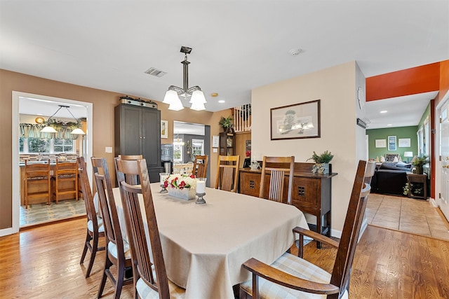 dining room featuring visible vents, light wood-style floors, baseboards, an inviting chandelier, and recessed lighting