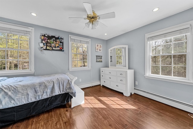 bedroom featuring lofted ceiling, ceiling fan, baseboard heating, recessed lighting, and wood finished floors
