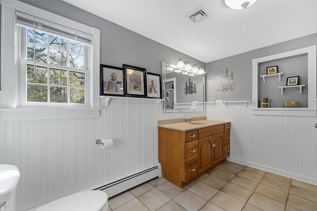 bathroom with toilet, visible vents, wainscoting, and tile patterned floors