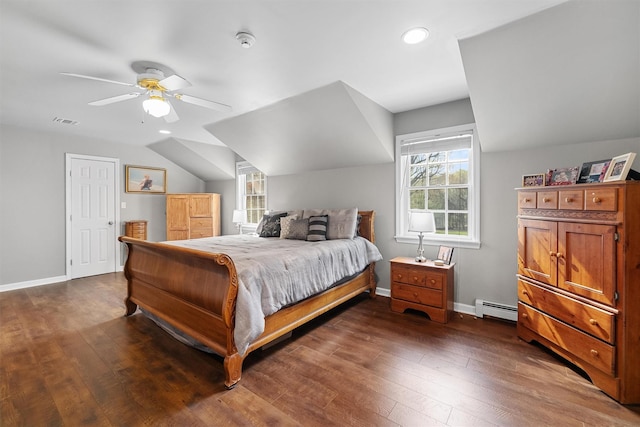 bedroom featuring vaulted ceiling, baseboards, a baseboard heating unit, and wood-type flooring