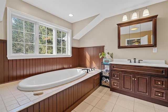 bathroom featuring a bath, a wainscoted wall, tile patterned floors, and vanity