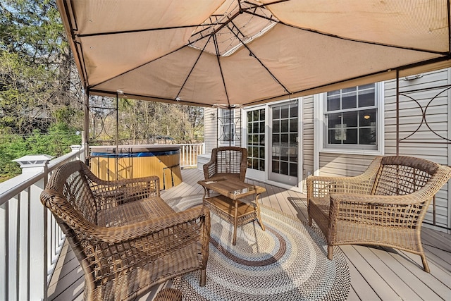 wooden deck with a hot tub
