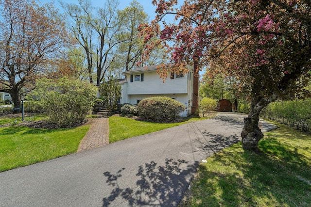 103 S Nauraushaun Rd, Pearl River, NY 10965 - view of front facade with aphalt driveway and a front lawn