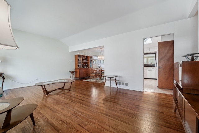 103 S Nauraushaun Rd, Pearl River, NY 10965 - sitting room featuring visible vents, wood finished floors, and vaulted ceiling