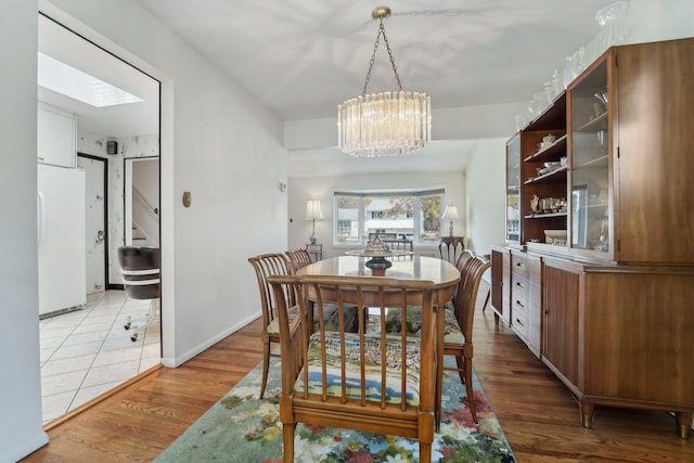 103 S Nauraushaun Rd, Pearl River, NY 10965 - dining area featuring stairway, a chandelier, and light wood-style floors