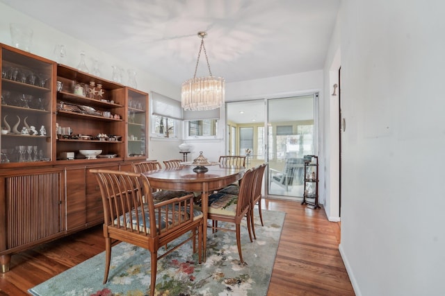 103 S Nauraushaun Rd, Pearl River, NY 10965 - dining space with an inviting chandelier, wood finished floors, and baseboards