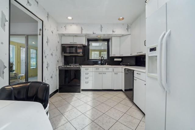 103 S Nauraushaun Rd, Pearl River, NY 10965 - kitchen with light tile patterned flooring, tasteful backsplash, black appliances, light countertops, and white cabinets