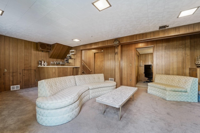 103 S Nauraushaun Rd, Pearl River, NY 10965 - living room featuring visible vents, wood walls, and carpet flooring