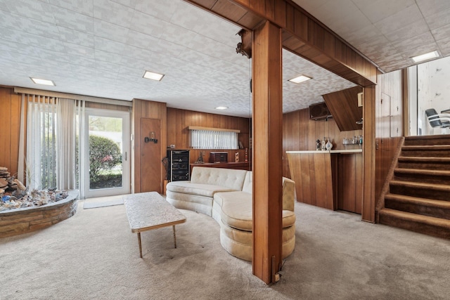 103 S Nauraushaun Rd, Pearl River, NY 10965 - living area featuring wooden walls, stairway, carpet, and beverage cooler