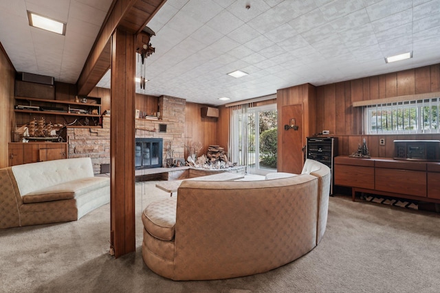 103 S Nauraushaun Rd, Pearl River, NY 10965 - carpeted living area featuring wine cooler, a wall unit AC, wood walls, and a fireplace