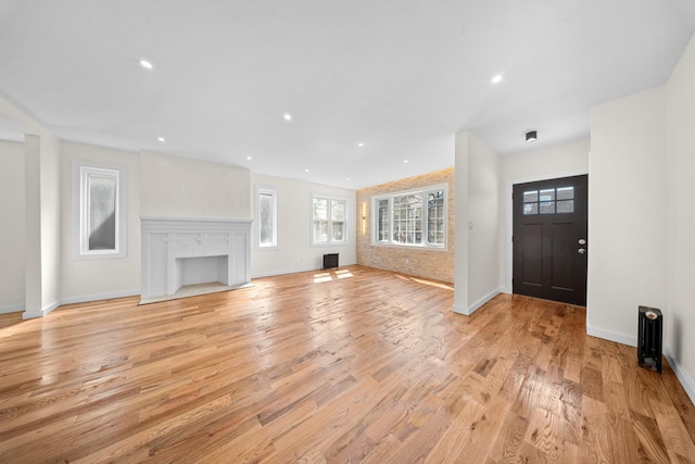 13107 229th St, Laurelton, NY 11413 - foyer featuring a fireplace, baseboards, and light wood-type flooring