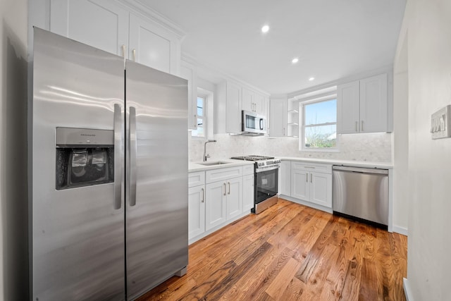 13107 229th St, Laurelton, NY 11413 - kitchen with stainless steel appliances, light countertops, backsplash, and white cabinetry