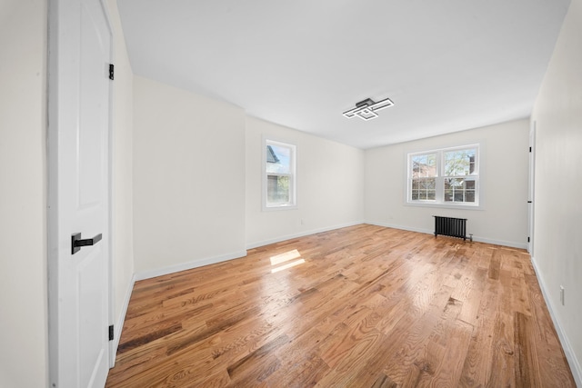 13107 229th St, Laurelton, NY 11413 - interior space with baseboards, radiator heating unit, and light wood-style floors