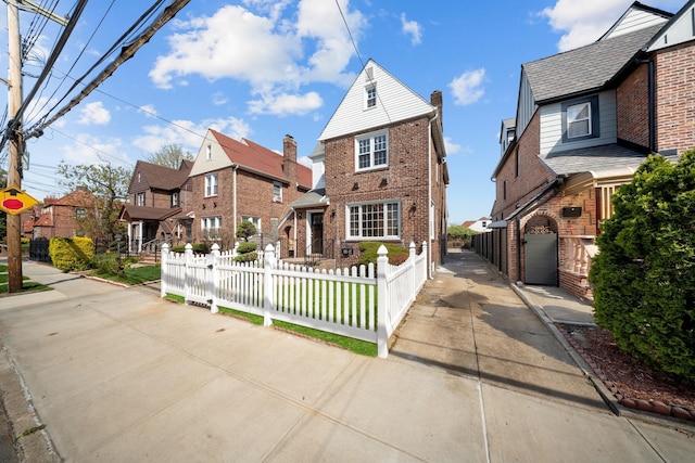 13107 229th St, Laurelton, NY 11413 - view of front of property with brick siding, a residential view, and a fenced front yard