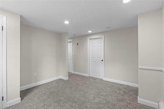 below grade area featuring recessed lighting, a baseboard radiator, carpet floors, and baseboards