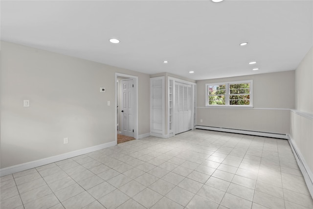 spare room featuring light tile patterned floors, baseboard heating, a baseboard heating unit, baseboards, and recessed lighting