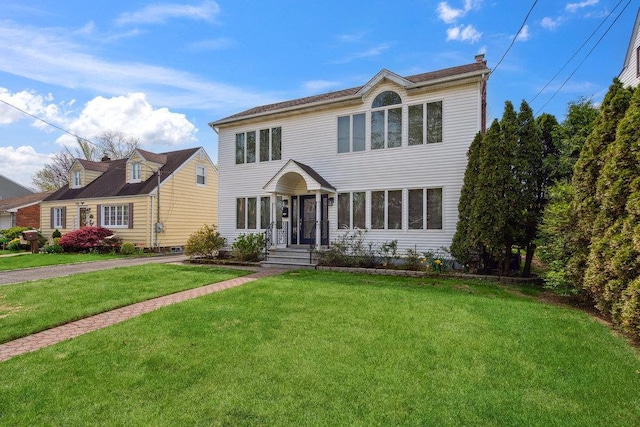 44 Netz Pl, Albertson, NY 11507 - colonial home featuring a chimney and a front yard
