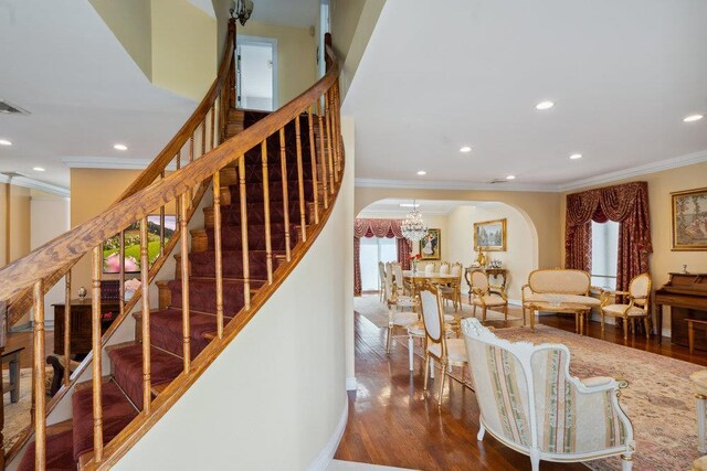 44 Netz Pl, Albertson, NY 11507 - stairway featuring ornamental molding, recessed lighting, arched walkways, and wood finished floors