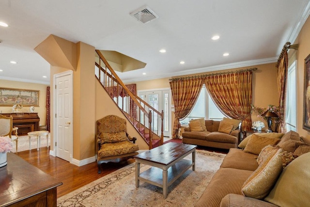 44 Netz Pl, Albertson, NY 11507 - living area with ornamental molding, stairs, visible vents, and wood finished floors