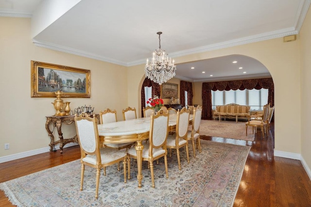 44 Netz Pl, Albertson, NY 11507 - dining space featuring crown molding, arched walkways, a notable chandelier, and wood finished floors
