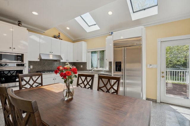44 Netz Pl, Albertson, NY 11507 - dining room with a wealth of natural light, crown molding, and lofted ceiling with skylight