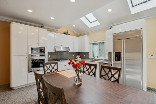 44 Netz Pl, Albertson, NY 11507 - dining space featuring granite finish floor, lofted ceiling with skylight, recessed lighting, and ornamental molding