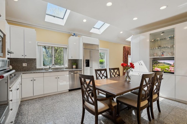 44 Netz Pl, Albertson, NY 11507 - dining room featuring granite finish floor, ornamental molding, and a skylight