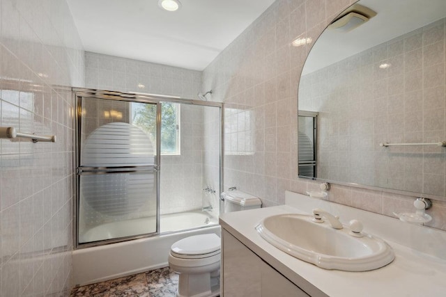 44 Netz Pl, Albertson, NY 11507 - full bathroom with bath / shower combo with glass door, vanity, toilet, and tile walls