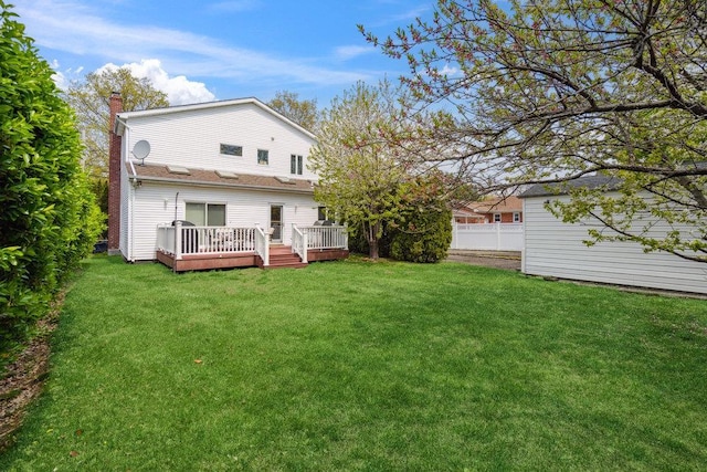 44 Netz Pl, Albertson, NY 11507 - rear view of property featuring fence, a chimney, a yard, and a wooden deck
