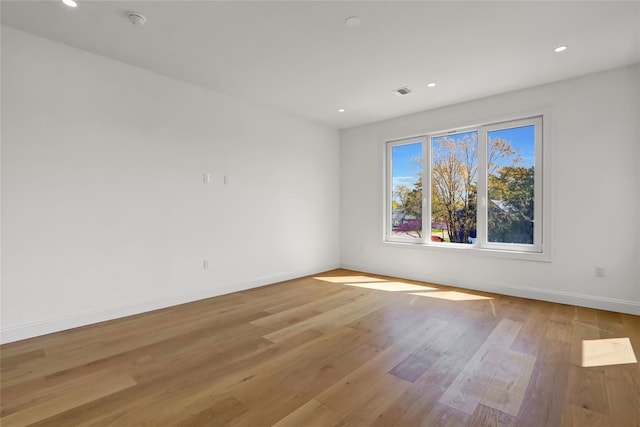 spare room with recessed lighting, light wood-style floors, visible vents, and baseboards