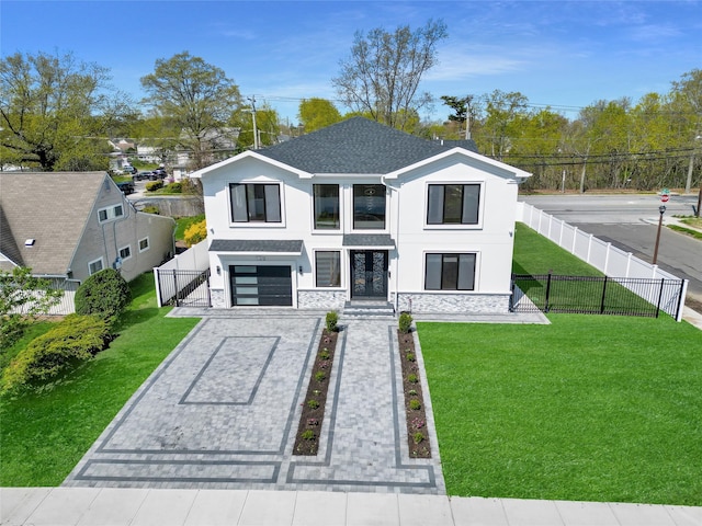 view of front of home with decorative driveway, stone siding, an attached garage, a front yard, and stucco siding