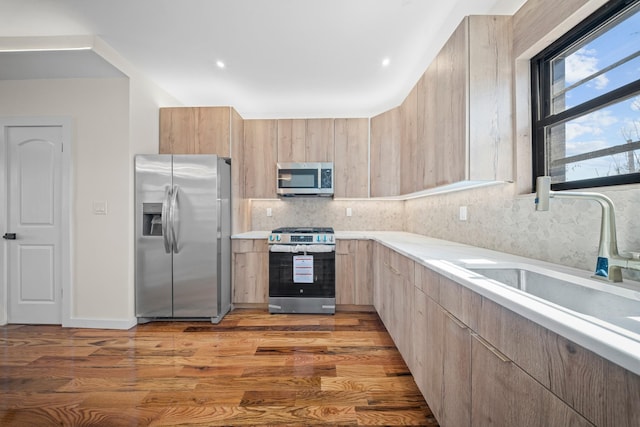 22518 Mentone Ave, Laurelton, NY 11413 - kitchen featuring stainless steel appliances, light brown cabinets, light countertops, and modern cabinets
