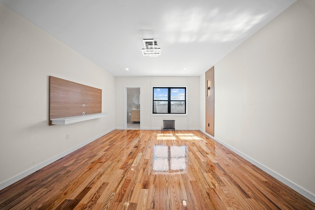 22518 Mentone Ave, Laurelton, NY 11413 - unfurnished living room featuring radiator heating unit, baseboards, and wood finished floors