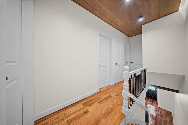 22518 Mentone Ave, Laurelton, NY 11413 - hallway with wood ceiling, baseboards, light wood finished floors, and an upstairs landing