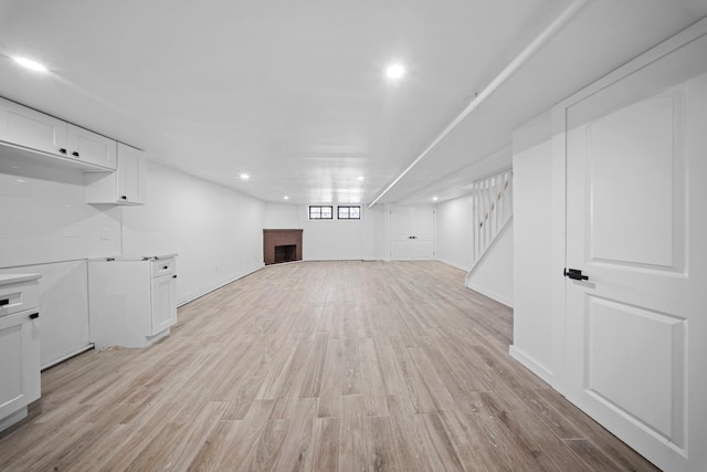 22518 Mentone Ave, Laurelton, NY 11413 - basement with recessed lighting, light wood-style floors, baseboards, and stairs