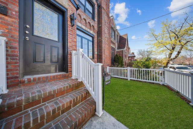 22518 Mentone Ave, Laurelton, NY 11413 - entrance to property featuring brick siding, fence, and a lawn