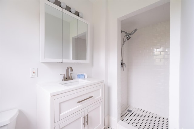 bathroom with a stall shower, toilet, and vanity