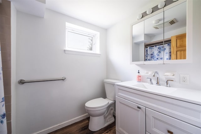 full bathroom with vanity, toilet, visible vents, wood finished floors, and a shower with shower curtain