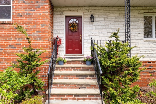 view of exterior entry featuring brick siding