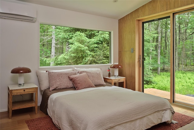64 Hoyt Rd, Glen Spey, NY 12737 - bedroom featuring a wall unit AC, access to outside, multiple windows, and wood finished floors
