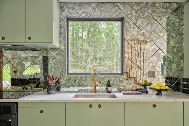 64 Hoyt Rd, Glen Spey, NY 12737 - kitchen featuring green cabinets, decorative backsplash, and light countertops