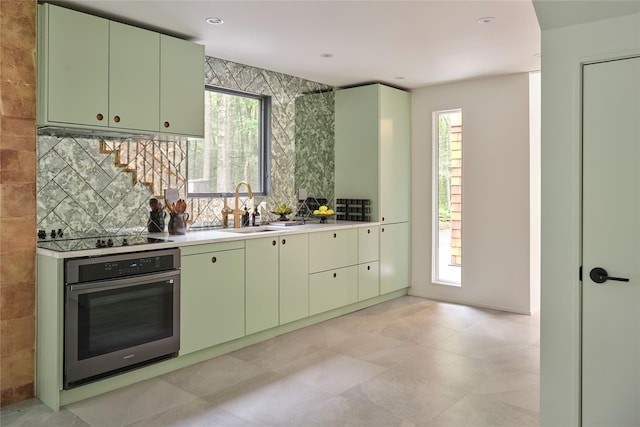 64 Hoyt Rd, Glen Spey, NY 12737 - kitchen with stainless steel oven, green cabinetry, black electric cooktop, and light countertops