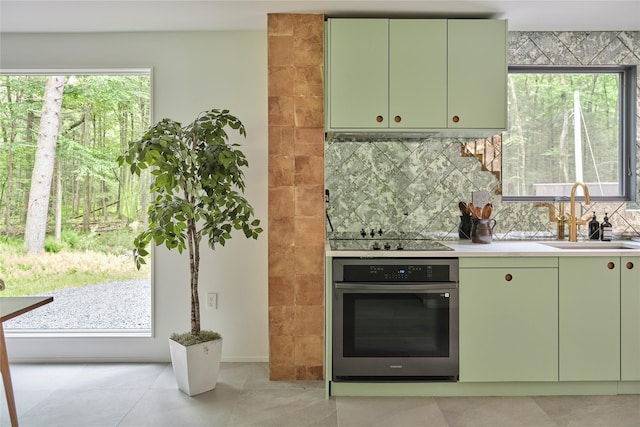 64 Hoyt Rd, Glen Spey, NY 12737 - kitchen featuring oven, green cabinets, black electric stovetop, backsplash, and light countertops