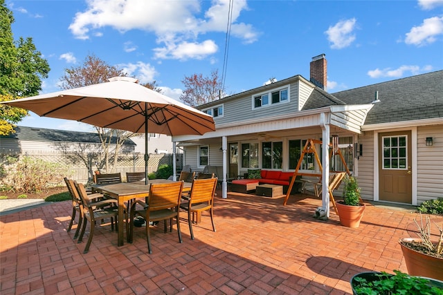 view of patio / terrace with ceiling fan, an outdoor living space, fence, and outdoor dining area