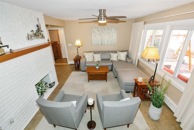 living area featuring a brick fireplace, ceiling fan, and baseboards