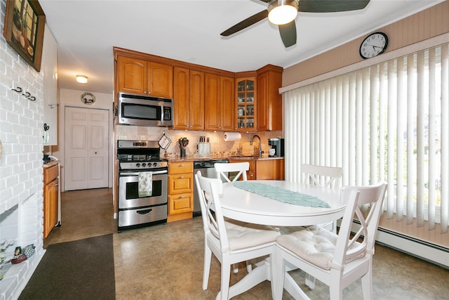 kitchen with appliances with stainless steel finishes, a healthy amount of sunlight, a ceiling fan, and a sink