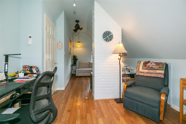 sitting room with lofted ceiling, wood finished floors, and baseboards