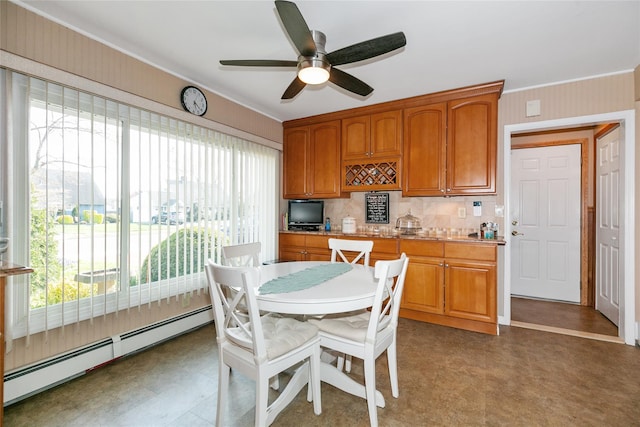 dining space with a baseboard heating unit, crown molding, a ceiling fan, and light floors