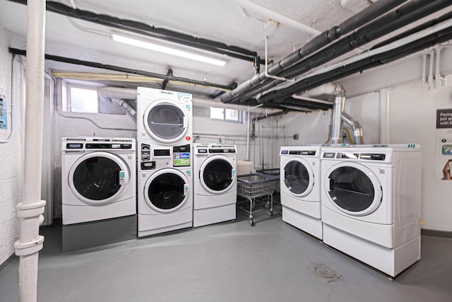 shared laundry area with separate washer and dryer, plenty of natural light, and stacked washer and clothes dryer