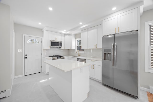 kitchen featuring backsplash, appliances with stainless steel finishes, white cabinetry, and recessed lighting